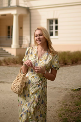 a lady in a yellow floral print dress